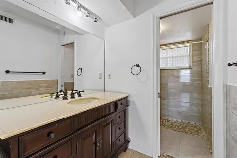 a bathroom with a toilet a window and shower