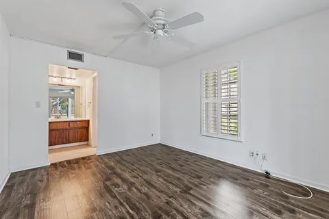 a kitchen with a refrigerator and white cabinets