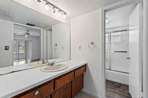 a bathroom with a shower a toilet and a window