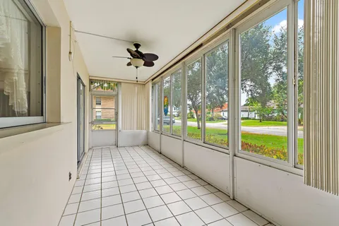 a view of empty room with wooden floor and windows