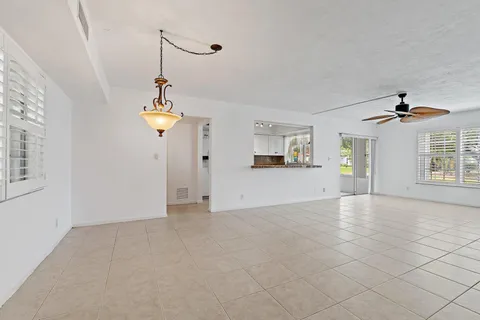 a view of a kitchen with wooden cabinet and a chandelier fan