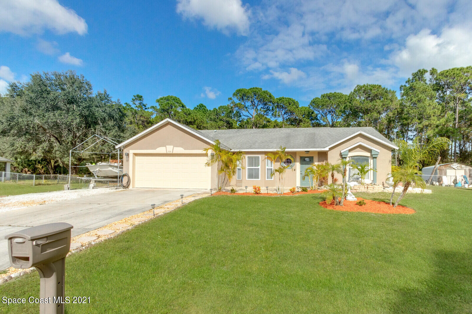 335 Gordon Road Northwest Palm Bay, FL 32907 - Photo 1 of 58 a front view of a house with a yard and garage