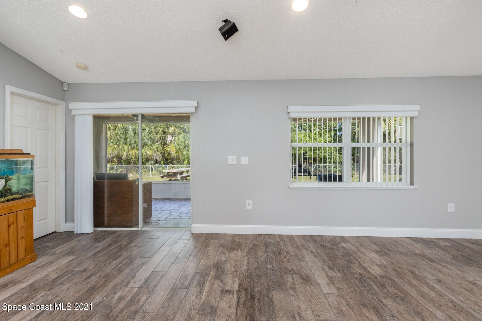 335 Gordon Road Northwest Palm Bay, FL 32907 - Photo 11 of 58 a view of an empty room with a window and wooden floor