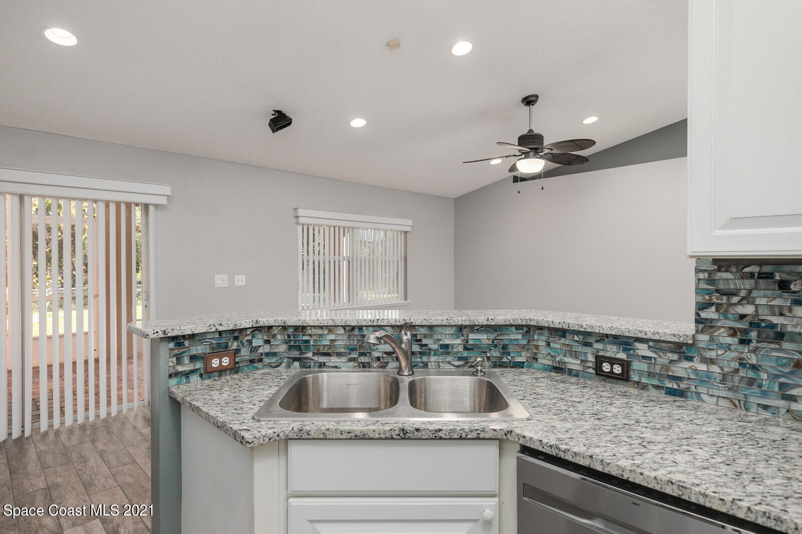 335 Gordon Road Northwest Palm Bay, FL 32907 - Photo 17 of 58 a bathroom with a granite countertop sink and a mirror