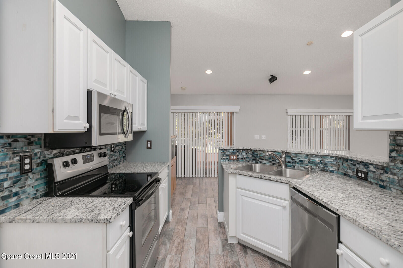 335 Gordon Road Northwest Palm Bay, FL 32907 - Photo 18 of 58 a kitchen with stainless steel appliances granite countertop a sink stove and cabinets