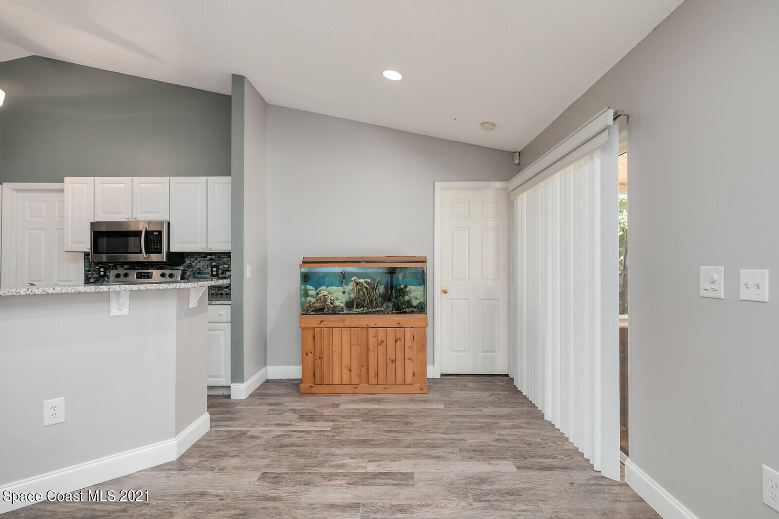 335 Gordon Road Northwest Palm Bay, FL 32907 - Photo 19 of 58 a view of a kitchen with a sink and a refrigerator