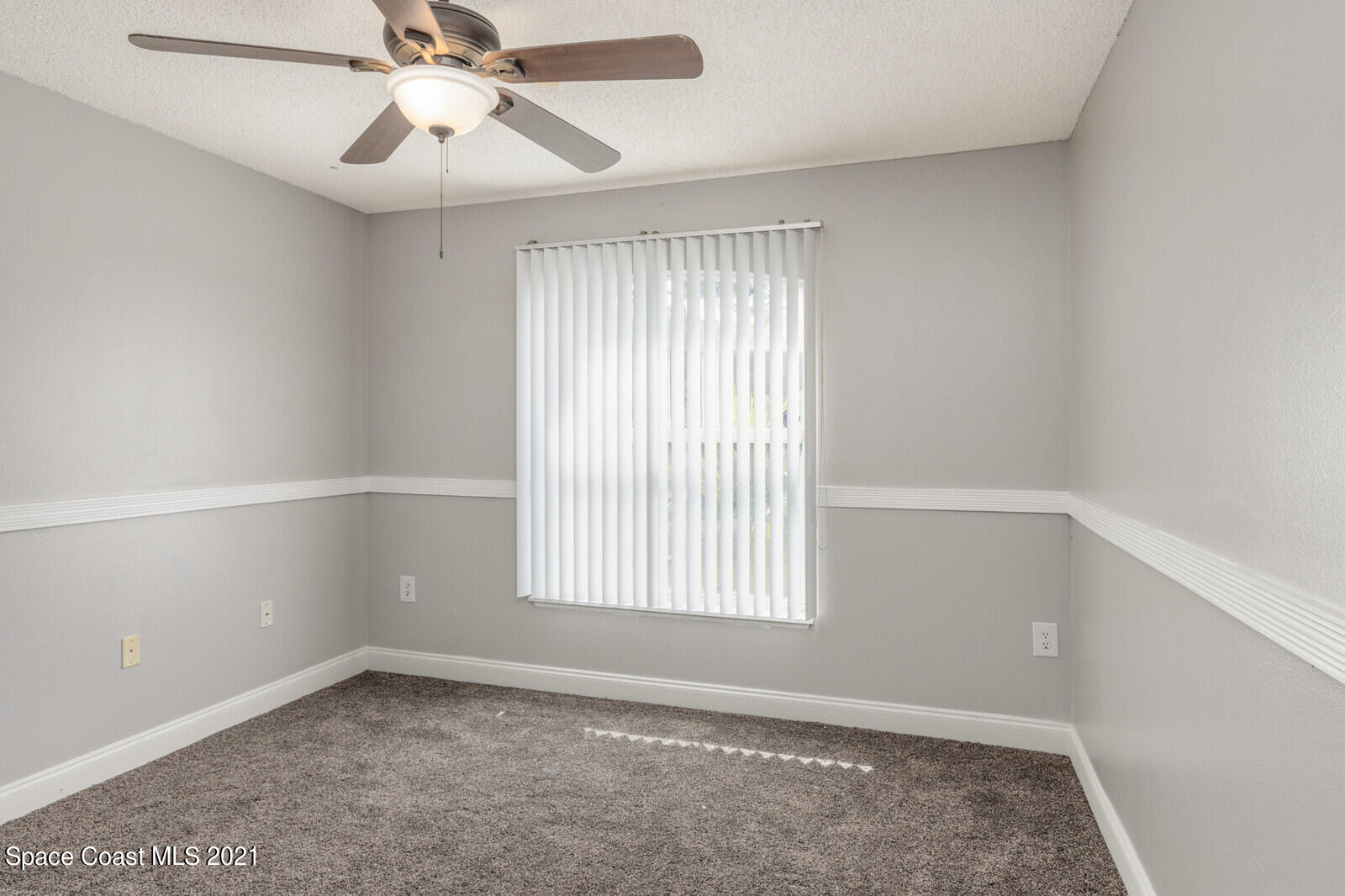 335 Gordon Road Northwest Palm Bay, FL 32907 - Photo 31 of 58 an empty room with a window and a fan