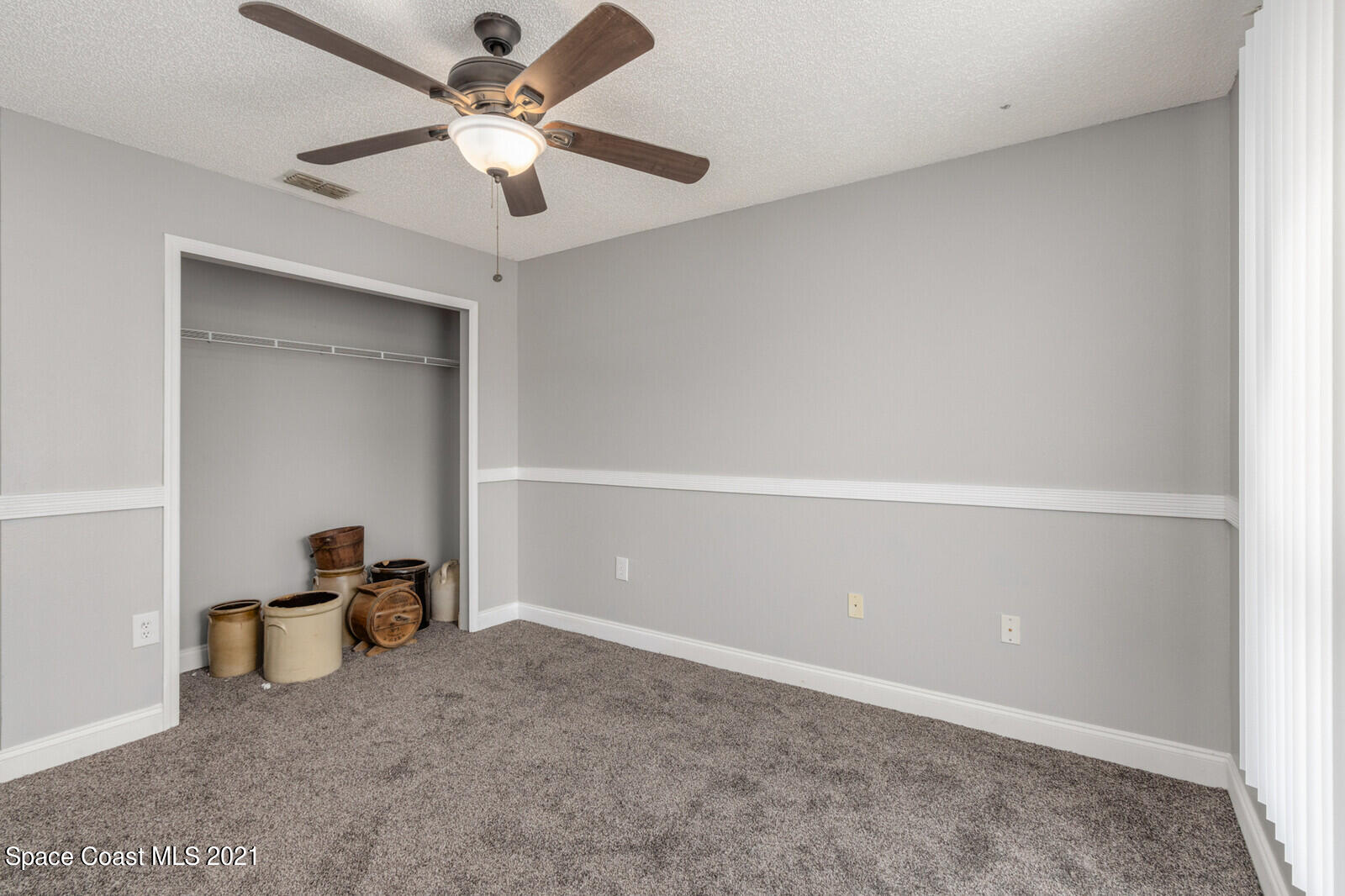 335 Gordon Road Northwest Palm Bay, FL 32907 - Photo 32 of 58 an empty room with closet and a ceiling fan