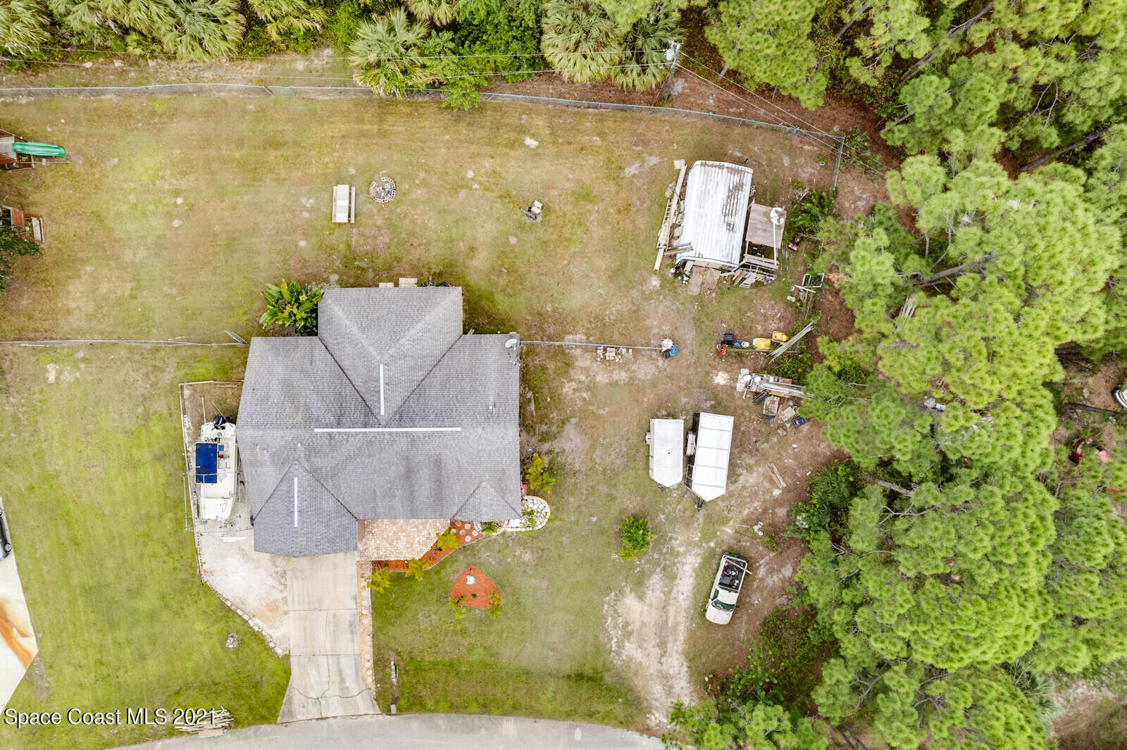 335 Gordon Road Northwest Palm Bay, FL 32907 - Photo 42 of 58 an aerial view of a house with a yard and large trees