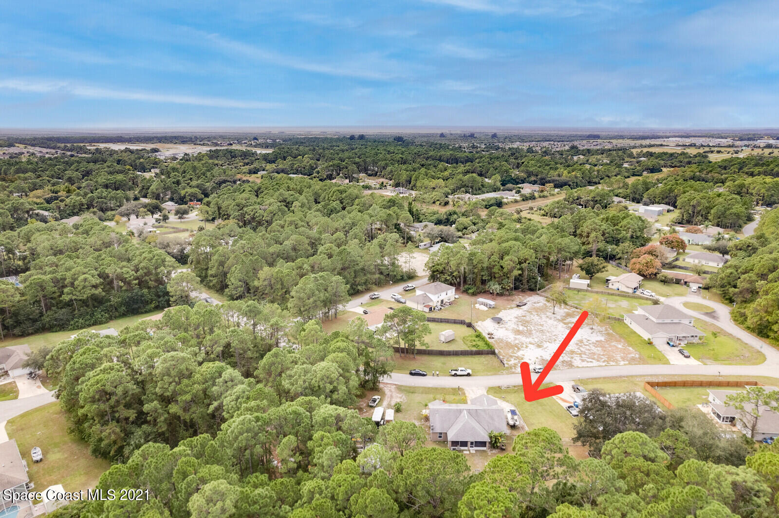 335 Gordon Road Northwest Palm Bay, FL 32907 - Photo 45 of 58 an aerial view of residential houses with outdoor space and trees