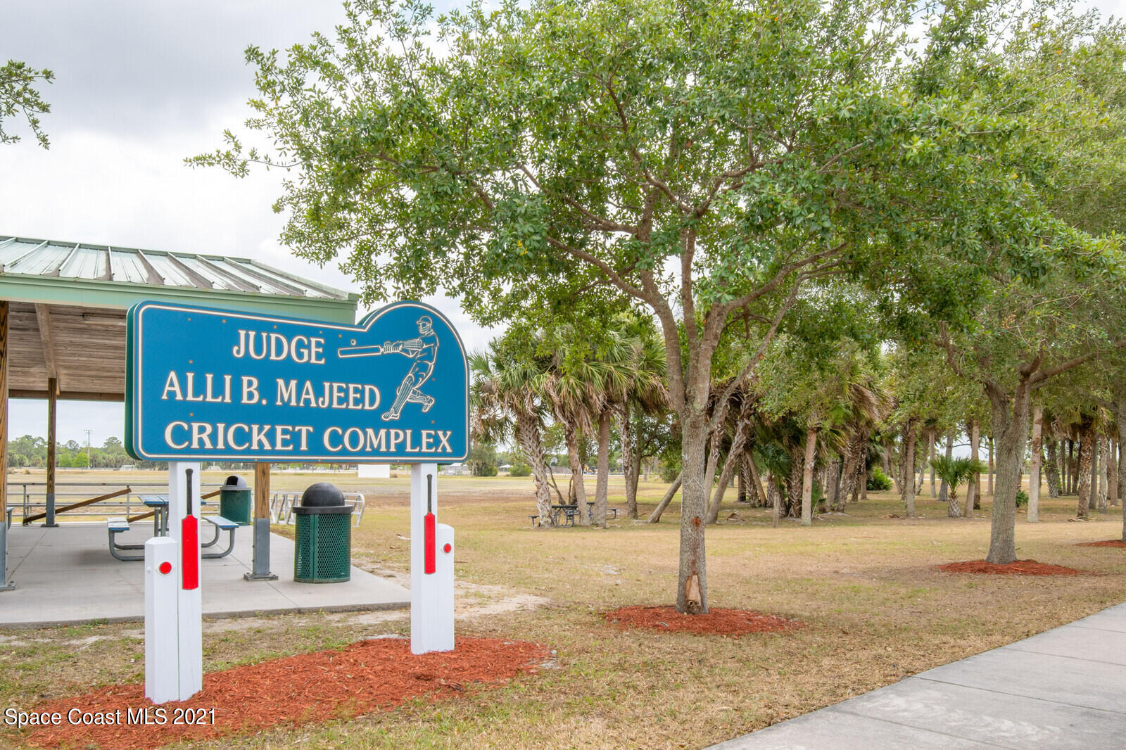 335 Gordon Road Northwest Palm Bay, FL 32907 - Photo 56 of 58 a street sign on a sidewalk next to a road
