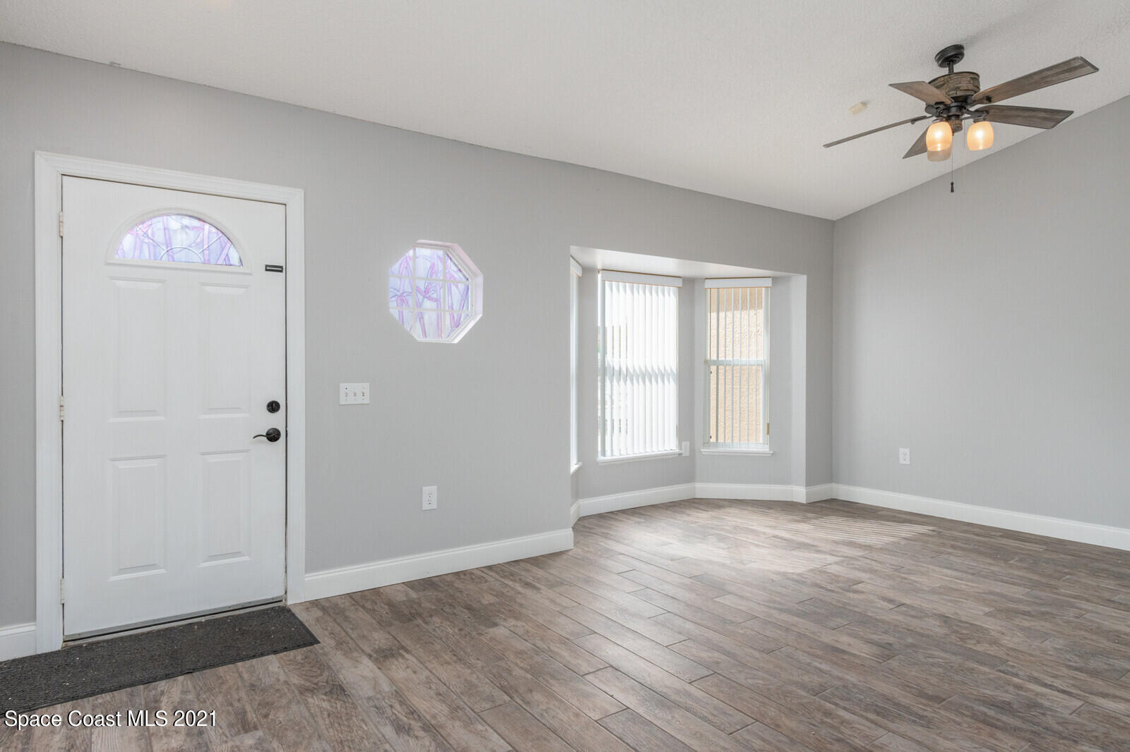 335 Gordon Road Northwest Palm Bay, FL 32907 - Photo 6 of 58 wooden floor in an empty room with a window