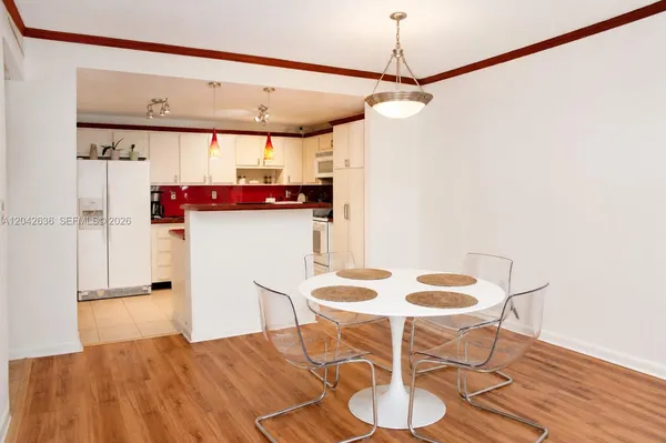 a view of a dining room with furniture and wooden floor