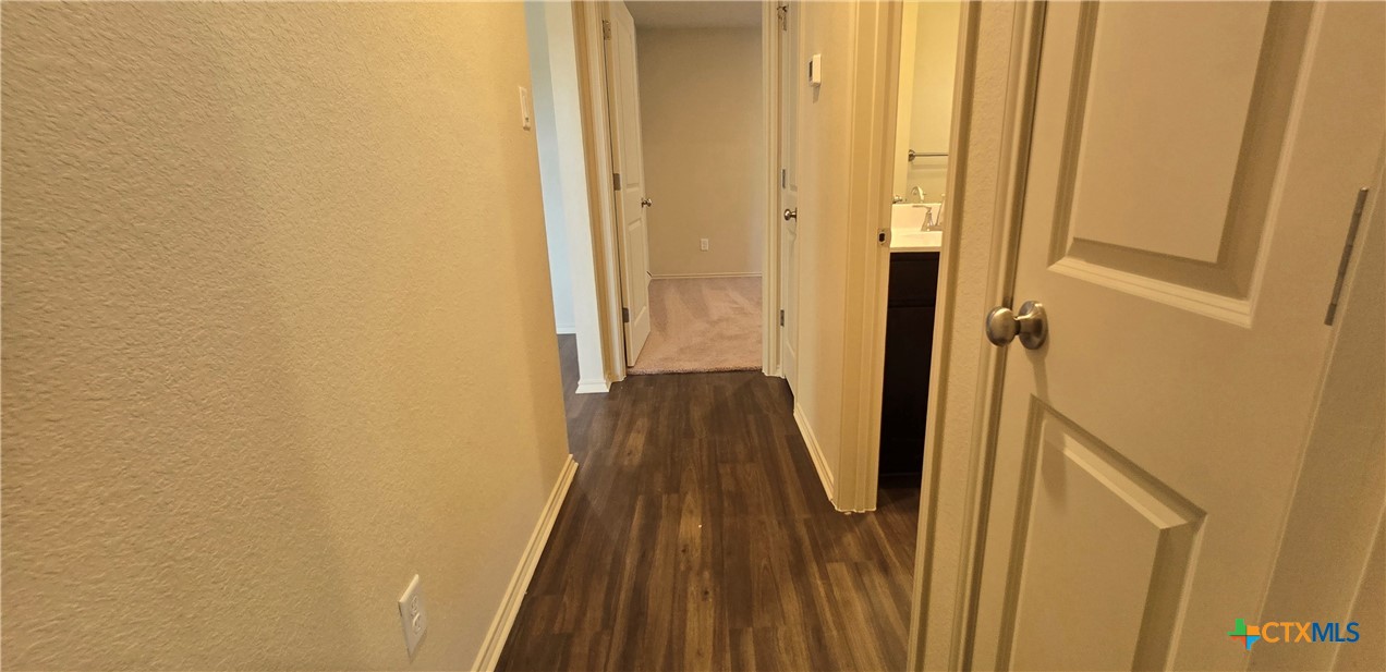 338 Monty Road Copperas Cove, TX 76522 - Photo 11 of 14 a view of a hallway with wooden floor