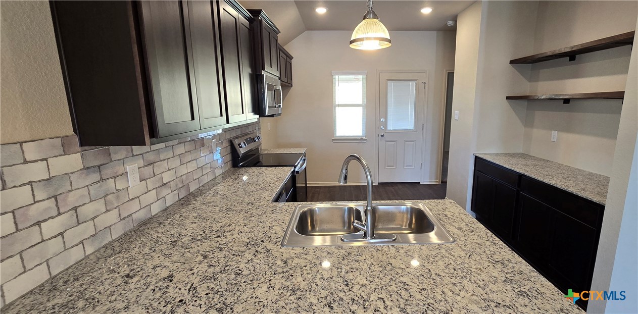 338 Monty Road Copperas Cove, TX 76522 - Photo 4 of 14 a bathroom with a sink a toilet and mirror