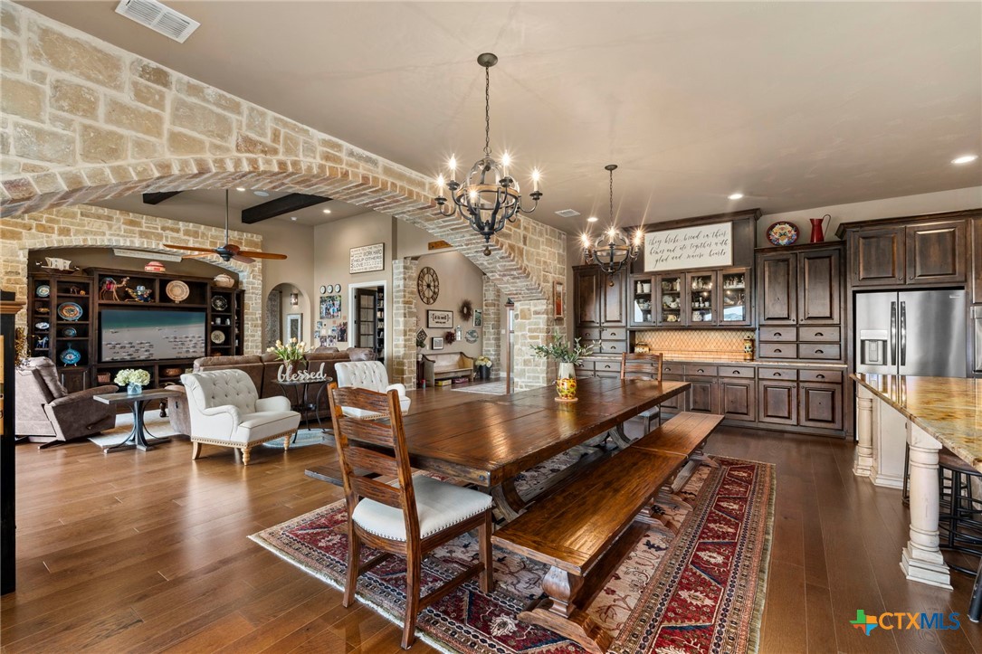 1039 Bluewater Place Spring Branch, TX 78070 - Photo 18 of 48 a living room with lots of furniture and a chandelier