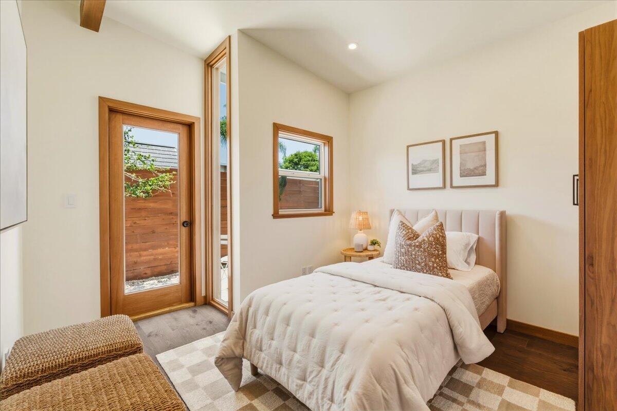 151 Kinman Avenue Goleta, CA 93117 - Photo 14 of 20 a bedroom with a bed and wooden floor