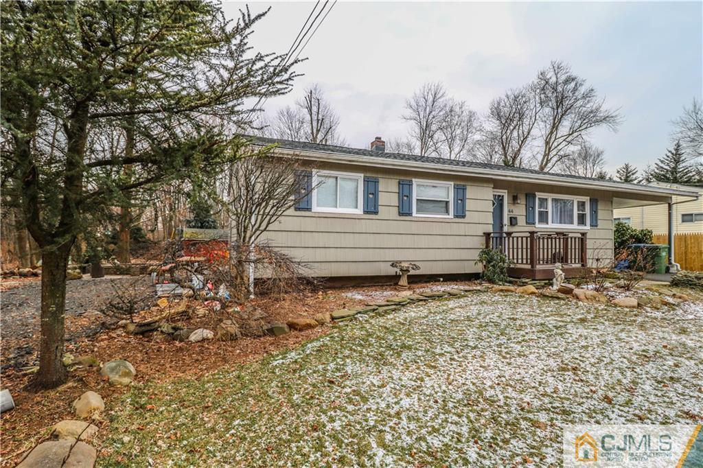44 Mill Road Edison, NJ 08817 - Photo 2 of 8 front view of a house with a dry trees