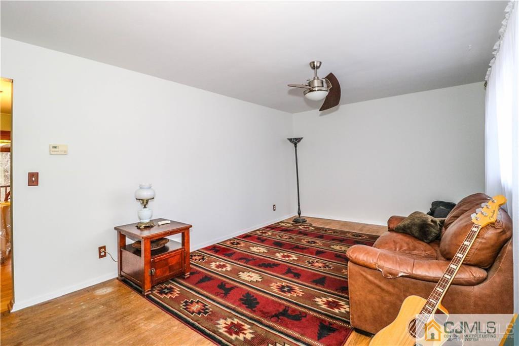44 Mill Road Edison, NJ 08817 - Photo 3 of 8 a bedroom with a bed and wooden floor