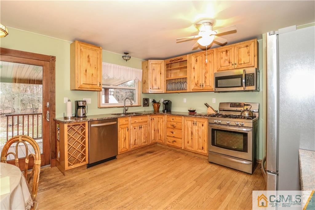 44 Mill Road Edison, NJ 08817 - Photo 4 of 8 a kitchen with stainless steel appliances granite countertop a stove a sink and a microwave