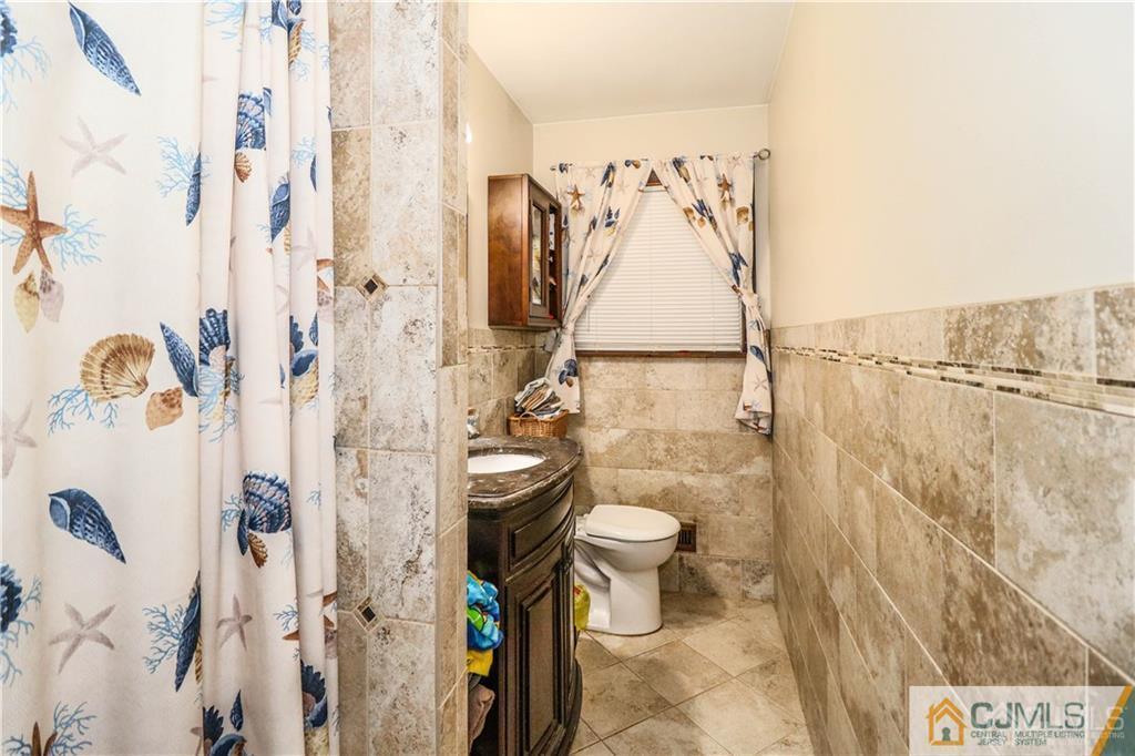 44 Mill Road Edison, NJ 08817 - Photo 6 of 8 a bathroom with a shower and a toilet