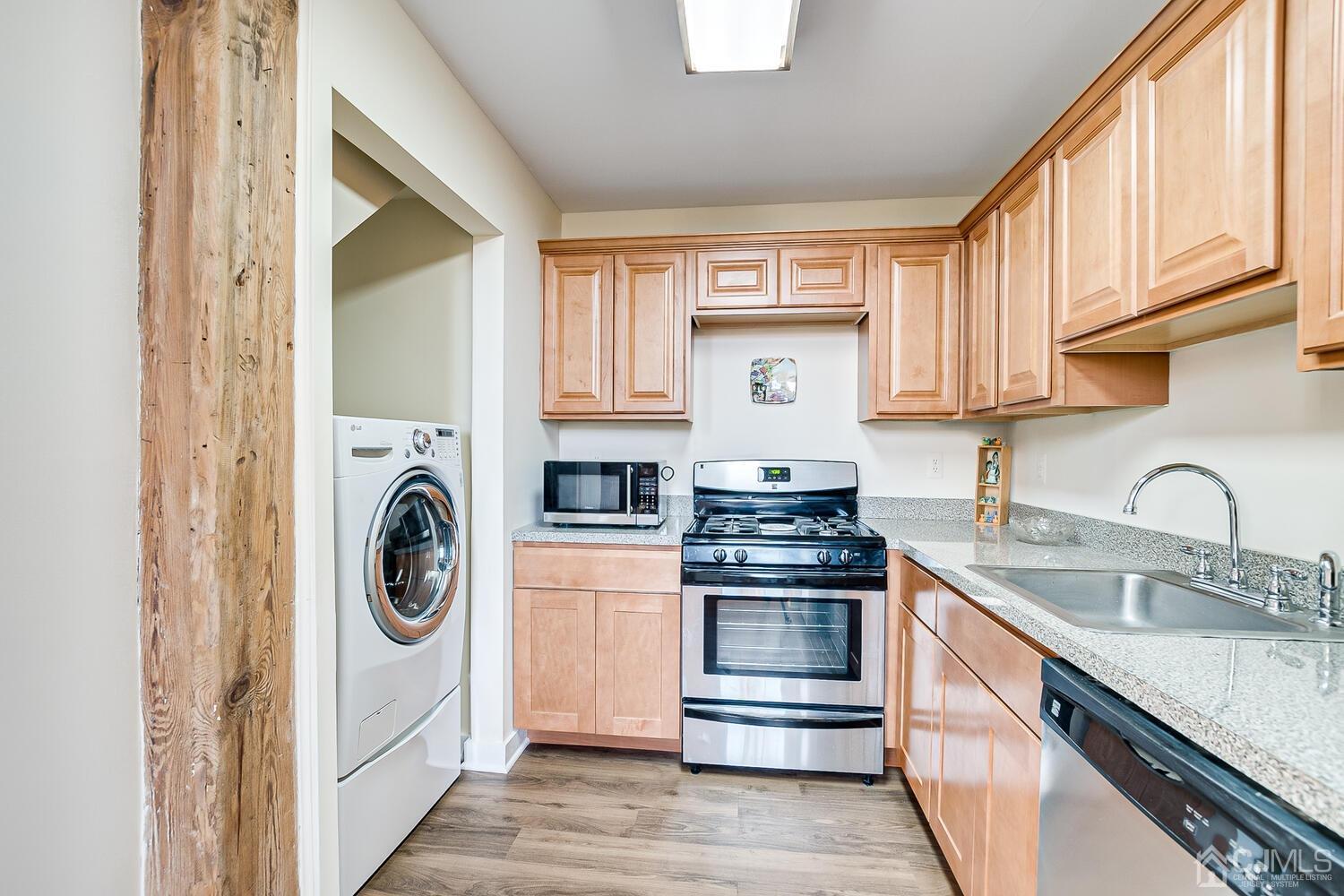 40 Washington Avenue, Unit 9 Milltown, NJ 08850 - Photo 25 of 43 a kitchen with a stove top oven sink and cabinets