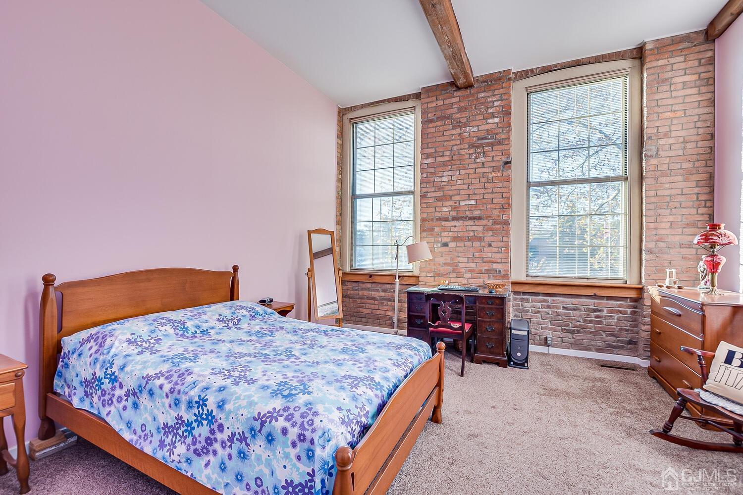 40 Washington Avenue, Unit 9 Milltown, NJ 08850 - Photo 33 of 43 a bedroom with a bed and a table in it