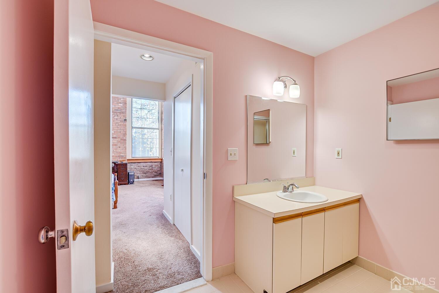 40 Washington Avenue, Unit 9 Milltown, NJ 08850 - Photo 36 of 43 a bathroom with a sink vanity and a mirror