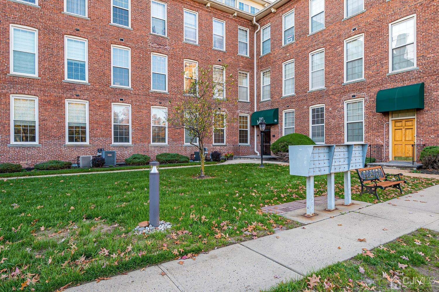 40 Washington Avenue, Unit 9 Milltown, NJ 08850 - Photo 9 of 43 a view of a brick building next to a yard