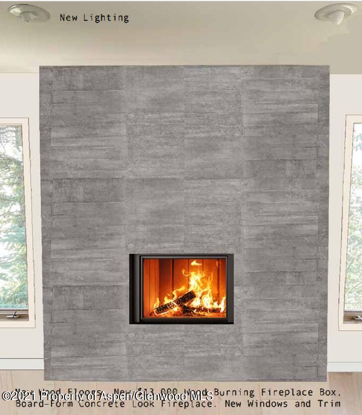 260 Meadow Ranch Road, Unit C21 Snowmass Village, CO 81615 - Photo 3 of 18 a view of a living room with a brick wall