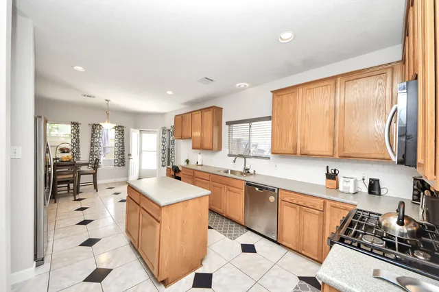 a bedroom with a large bed and wooden floor