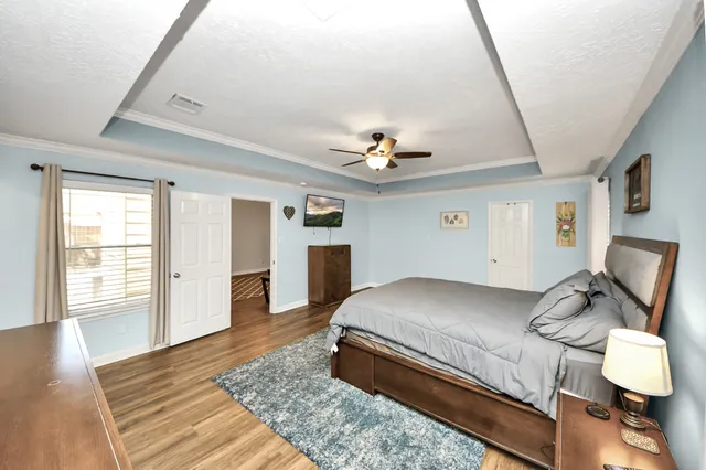 a bedroom with a bed and a chandelier