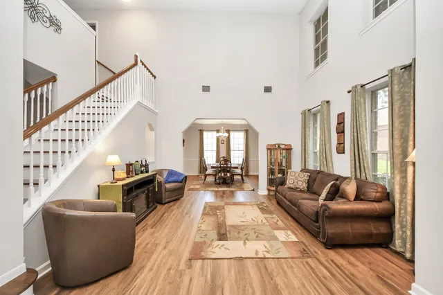 a living room with furniture fireplace and a large window