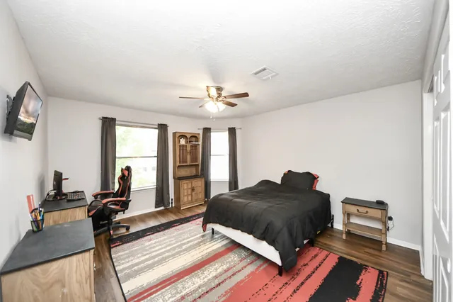 a view of a house with a yard and wooden fence