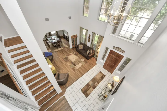 an aerial view of residential houses with outdoor space and swimming pool