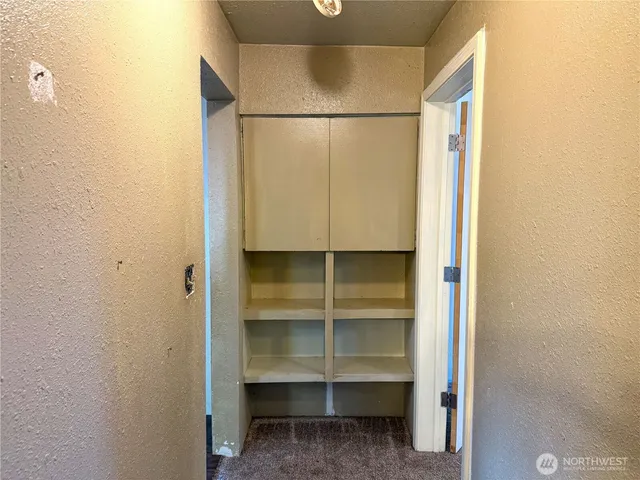 a view of walk in closet with empty racks