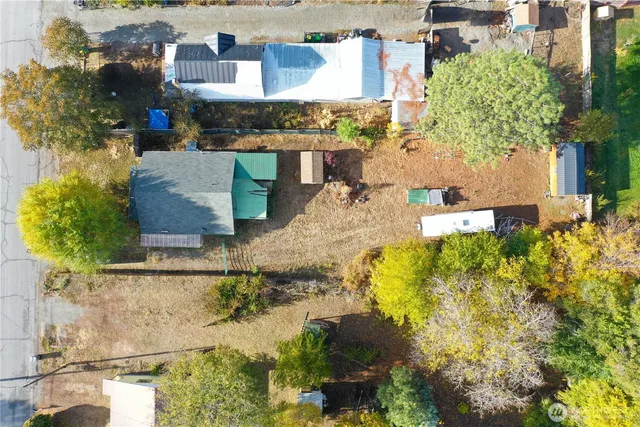 a view of a house with a patio and a yard