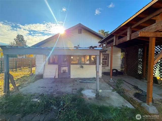 a view of a yard with wooden fence