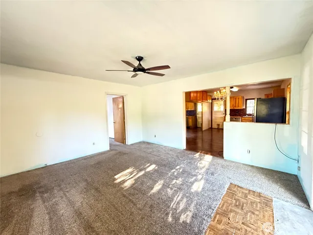 a view of a room with a ceiling fan