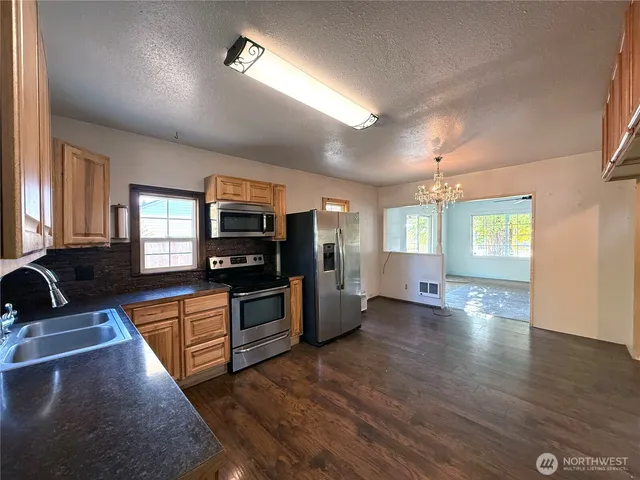 a kitchen with granite countertop a stove and a sink