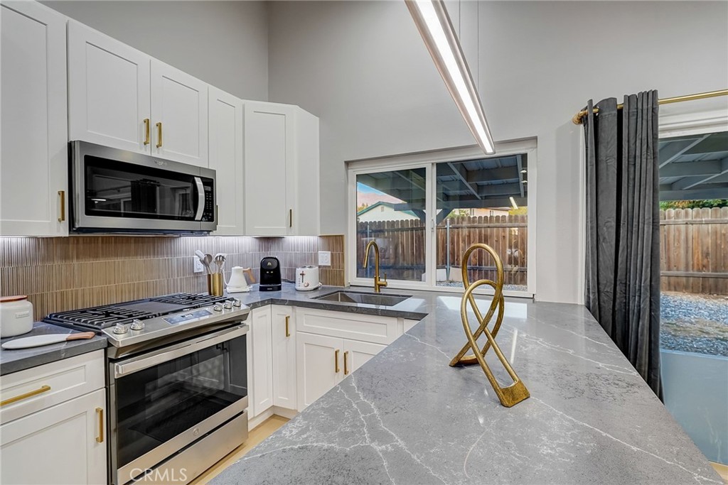5030 Kensington Way Riverside, CA 92507 - Photo 11 of 18 a kitchen with a sink appliances and cabinets