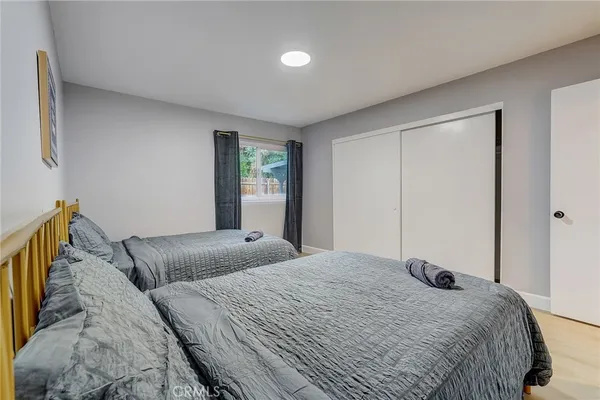 a bedroom with two beds and painting on the wall