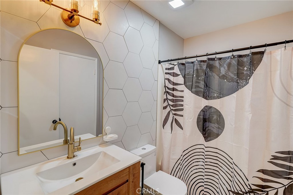 5030 Kensington Way Riverside, CA 92507 - Photo 17 of 18 a bathroom with a sink a toilet and shower