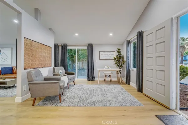 a living room with furniture rug and wooden floor