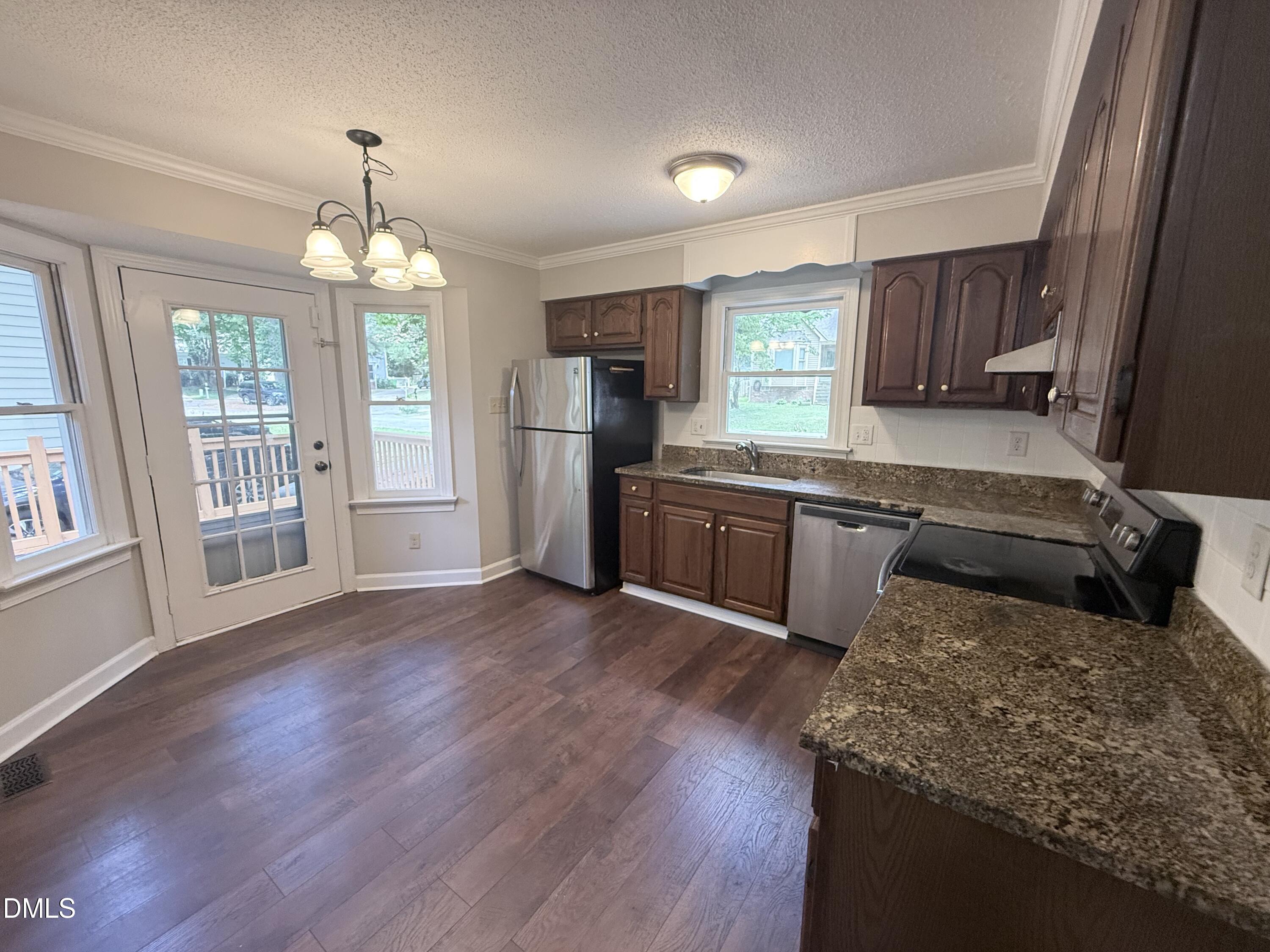 2900 Broadlands Drive Raleigh, NC 27604 - Photo 27 of 60 a kitchen with stainless steel appliances granite countertop wooden floors and granite counter tops