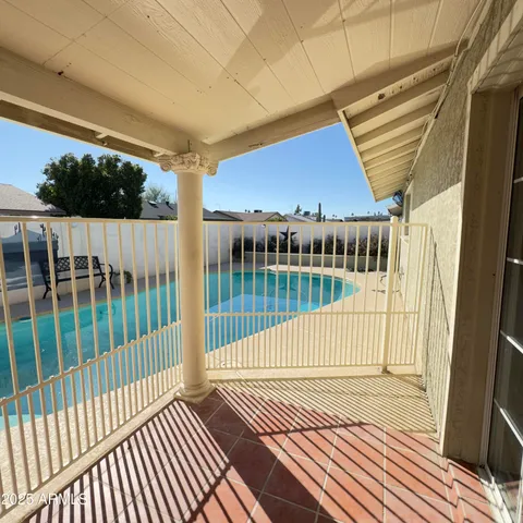 a view of a patio with table and chairs potted plants with wooden floor