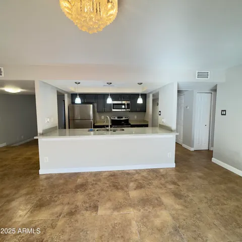 a hallway with stainless steel appliances a refrigerator and a stove