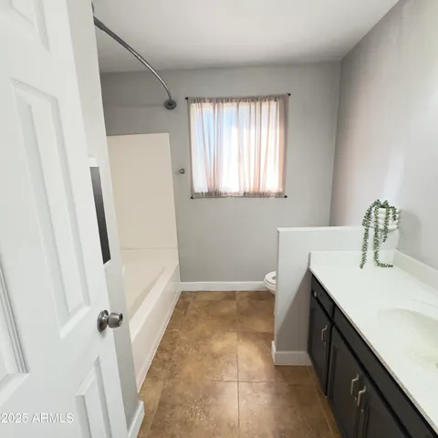 a view of a patio with dining table and chairs with a small yard