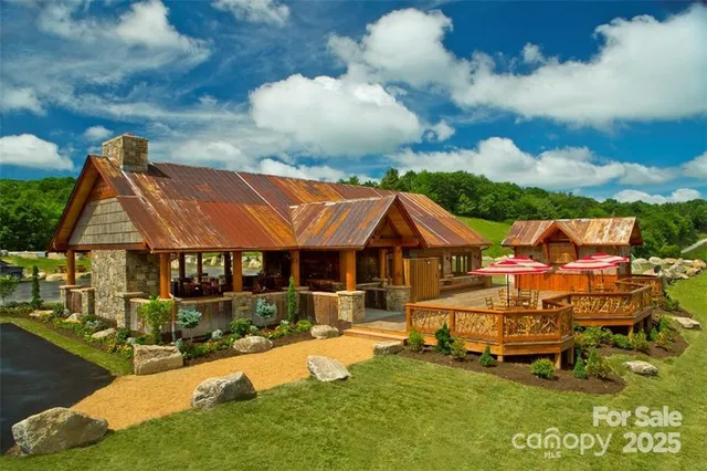 a view of swimming pool with outdoor seating and house in the background