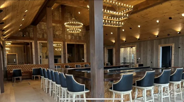 a large room with lots of table chair and a large window